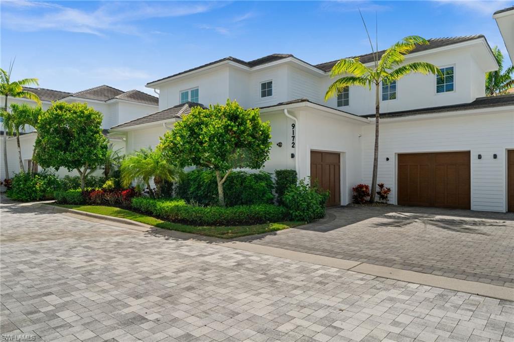 9172 Mercato Lane Naples, FL 34108 - Photo 2 of 29 View of front of house featuring decorative driveway, stucco siding, and a garage