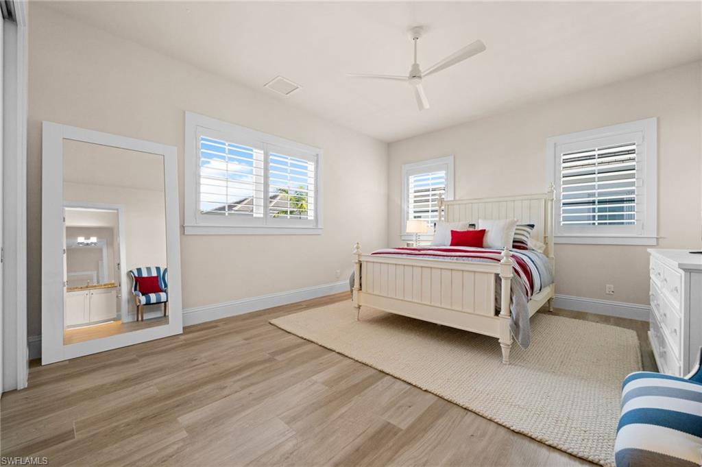 9172 Mercato Lane Naples, FL 34108 - Photo 22 of 29 Bedroom featuring light wood-style floors and a ceiling fan
