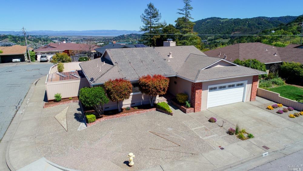 68 Ridgewood Drive San Rafael, CA 94901 - Photo 1 of 1 an aerial view of a house with a garden and mountain view