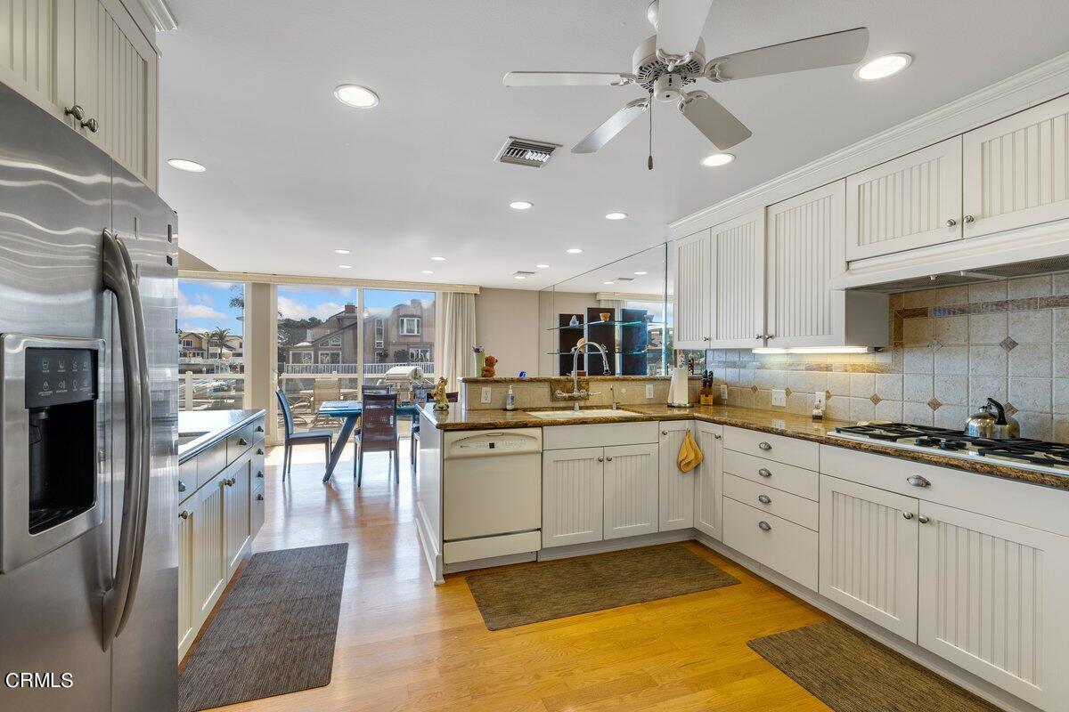 4530 Lyme Bay Oxnard, CA 93035 - Photo 11 of 46 a kitchen with stainless steel appliances granite countertop a sink and cabinets