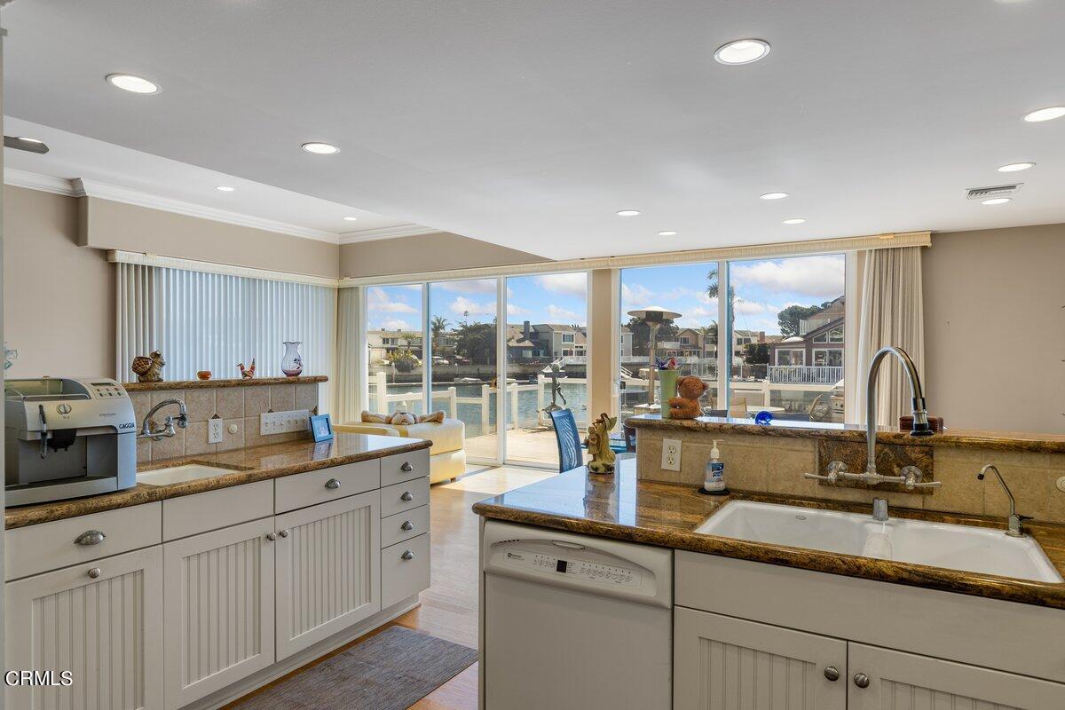 4530 Lyme Bay Oxnard, CA 93035 - Photo 12 of 46 a open kitchen with stainless steel appliances granite countertop a sink a stove and cabinets