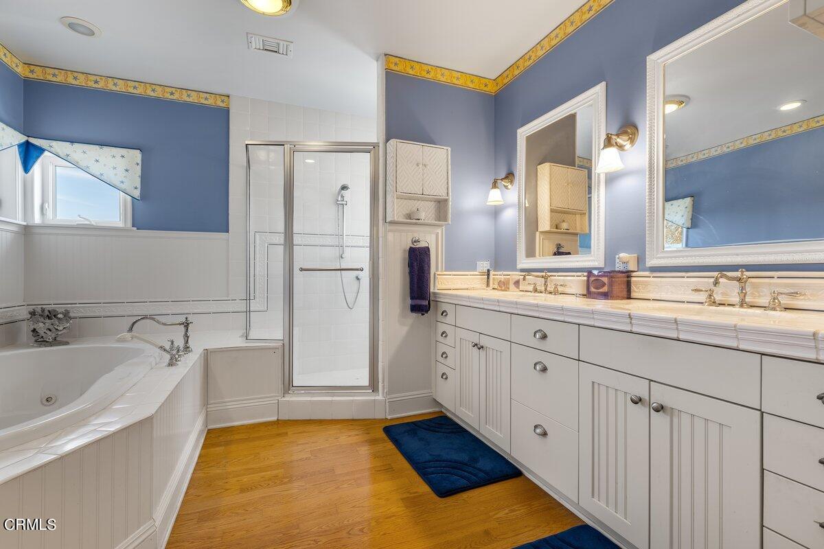 4530 Lyme Bay Oxnard, CA 93035 - Photo 22 of 46 a spacious bathroom with a tub sink and mirror