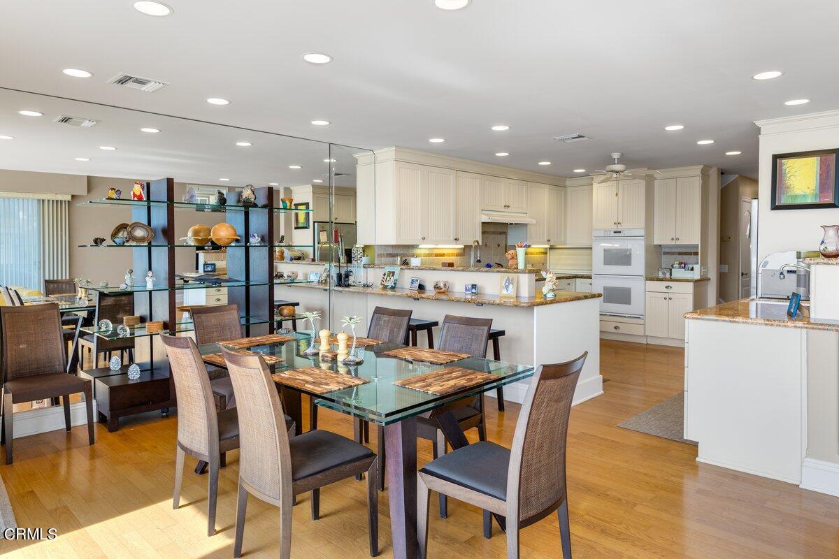 4530 Lyme Bay Oxnard, CA 93035 - Photo 7 of 46 a dining room with stainless steel appliances kitchen island granite countertop a stove a table and chairs