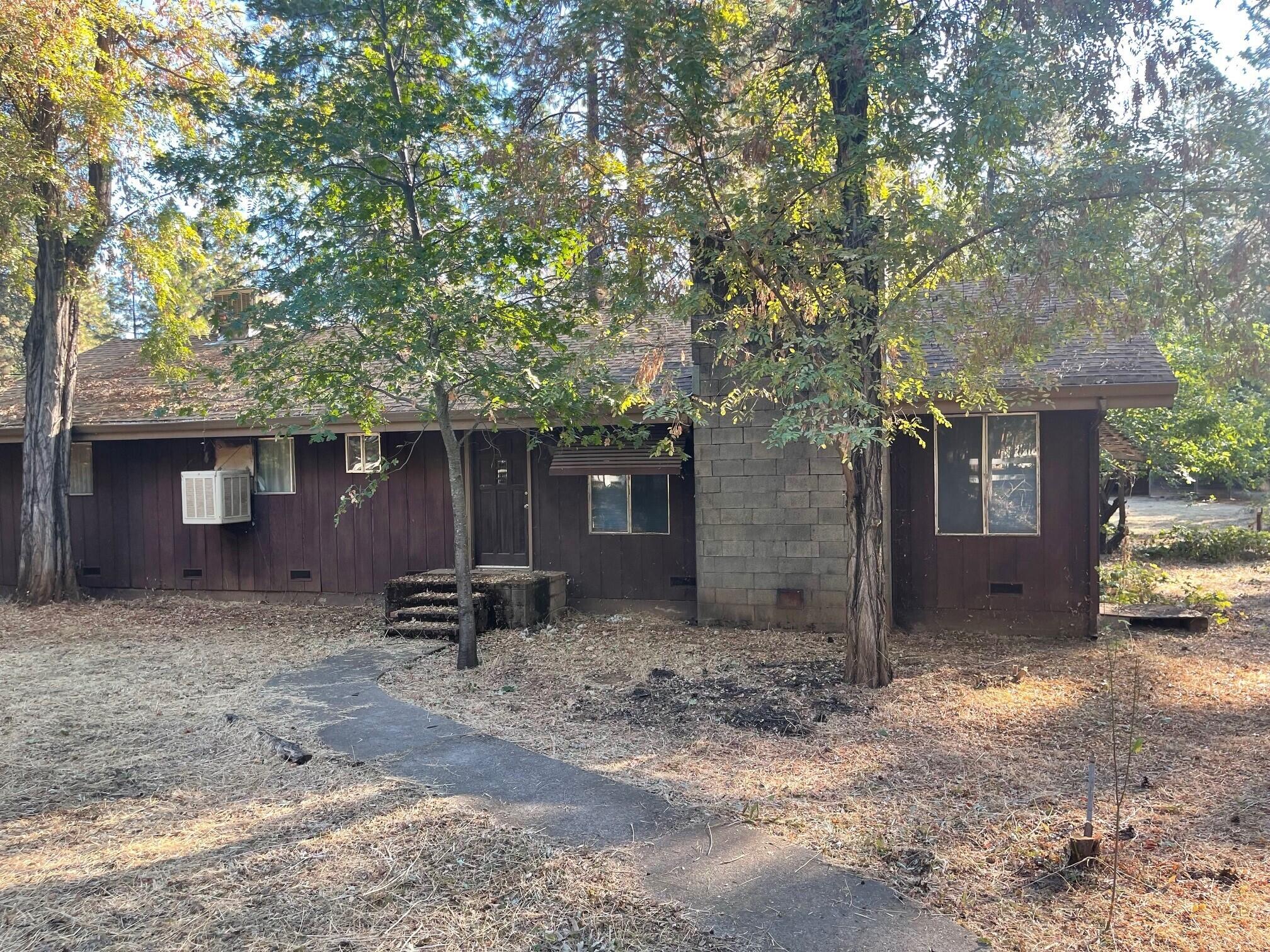 a couple of table and chairs in front of house