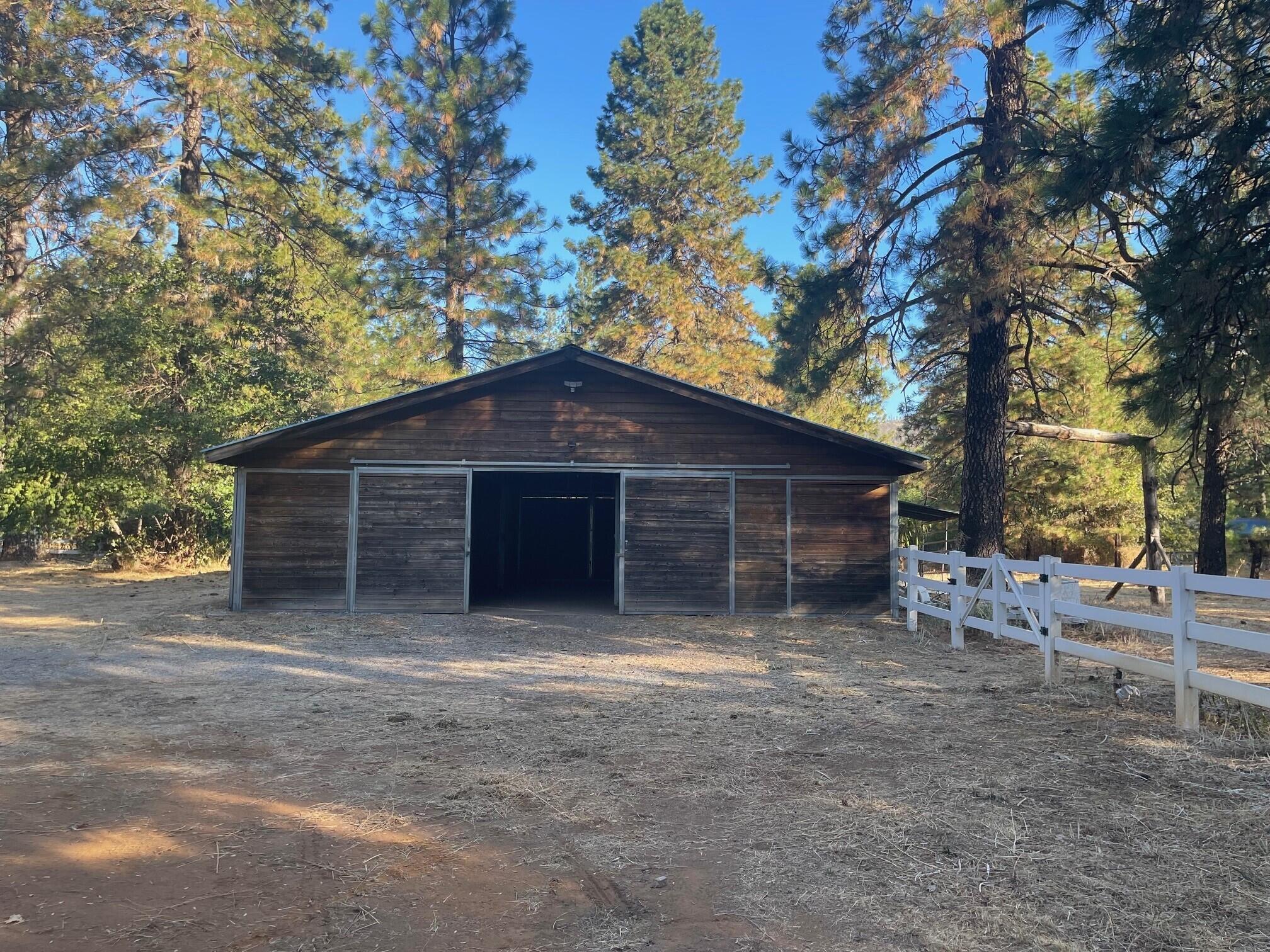 21565 Riverview Drive Lakehead, CA 96051 - Photo 3 of 6 a big house with large tree and wooden fence