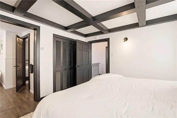 a bedroom with a bed and a large mirror
