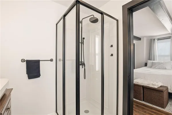 a bathroom with a shower and a sink