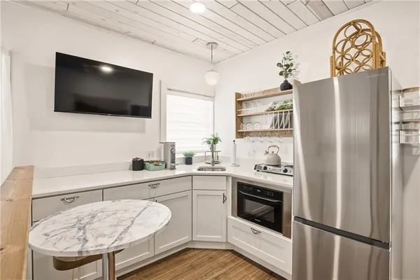 a spacious bedroom with a bed and a flat screen tv