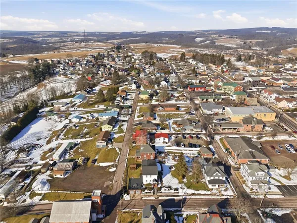 an aerial view of residential houses with city view