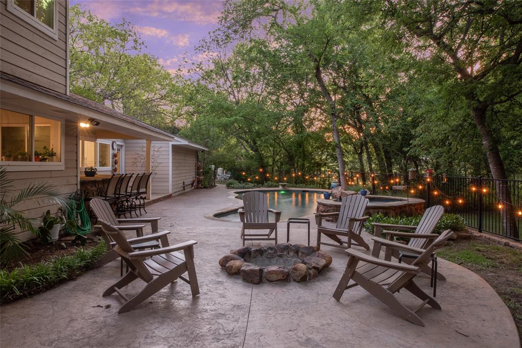 1451 Meandro Ria Lane Fairview, TX 75069 - Photo 5 of 38 a view of a patio with table and chairs with wooden fence and plants