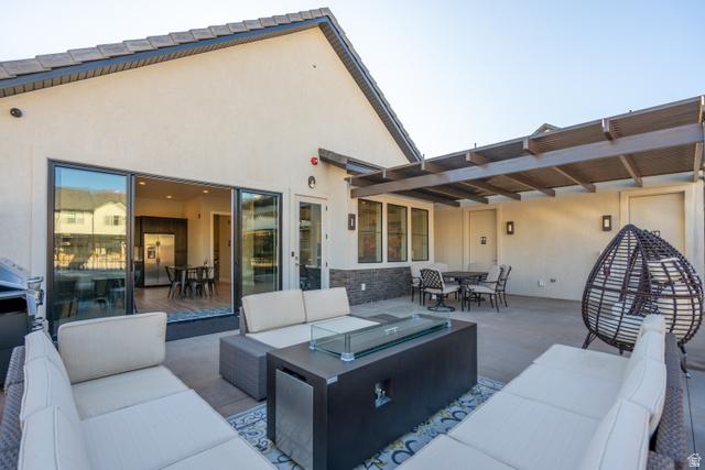 2600 Ocotillo Way, Unit 31 Santa Clara, UT 84765 - Photo 65 of 73 Spacious concrete patio featuring a modern gas fire pit, a partial pergola, and direct access to interior via sliding glass doors