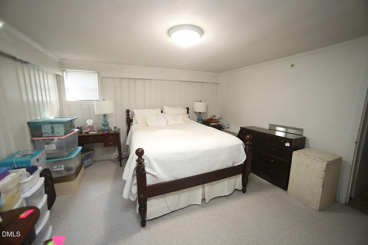 2601 York Road Raleigh, NC 27608 - Photo 17 of 24 a bedroom with a bed and a chair