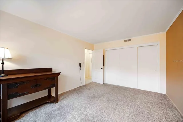 a view of an empty room and closet area