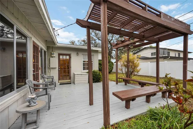 a building outdoor space with patio furniture and wooden floor
