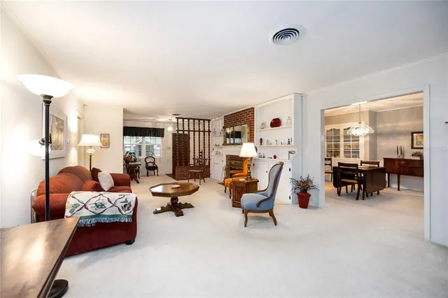 a living room with furniture and large windows