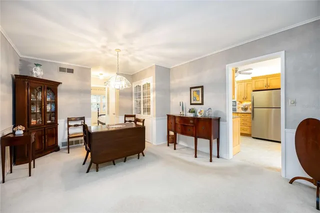 a living room with furniture and a kitchen area