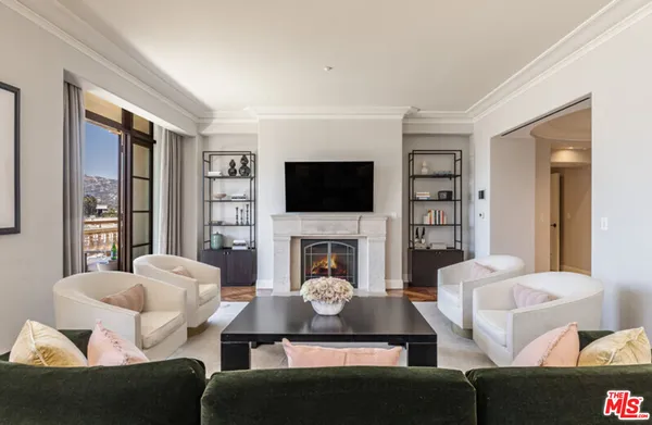 a living room with furniture a fireplace and a flat screen tv