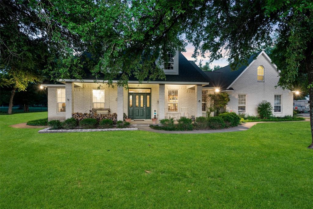 a view of house with a yard and garden