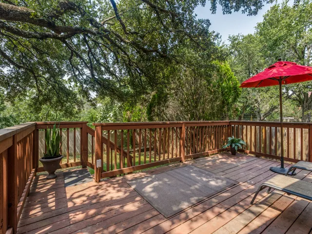 a view of balcony with wooden floor and outdoor seating