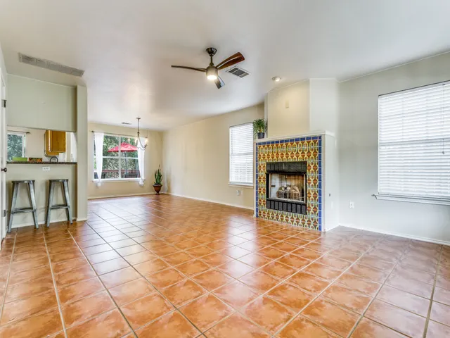 a view of a livingroom with wooden floor and a fireplace