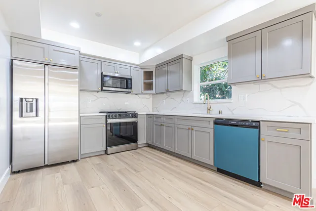 a kitchen with a refrigerator sink and microwave