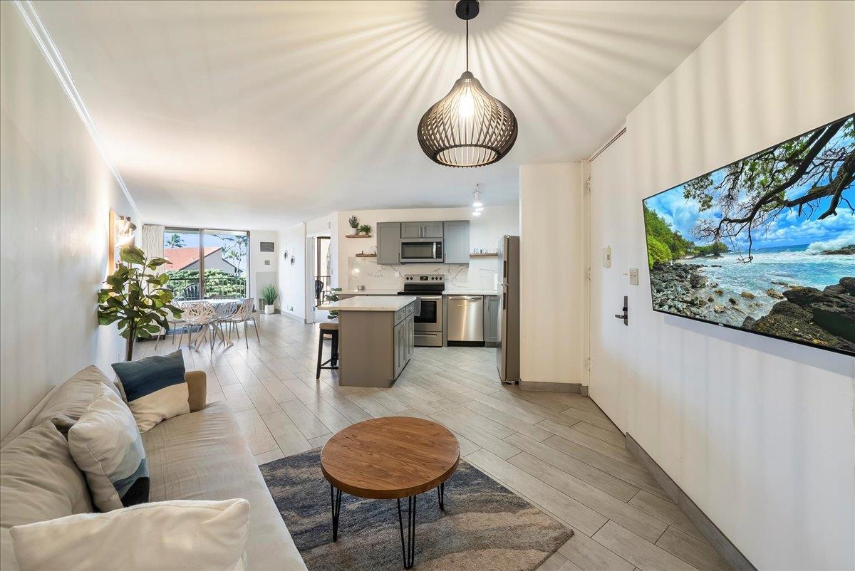 938 South Kihei Road, Unit 423 Kihei, HI 96753 - Photo 2 of 50 a living room with furniture a chandelier and kitchen view