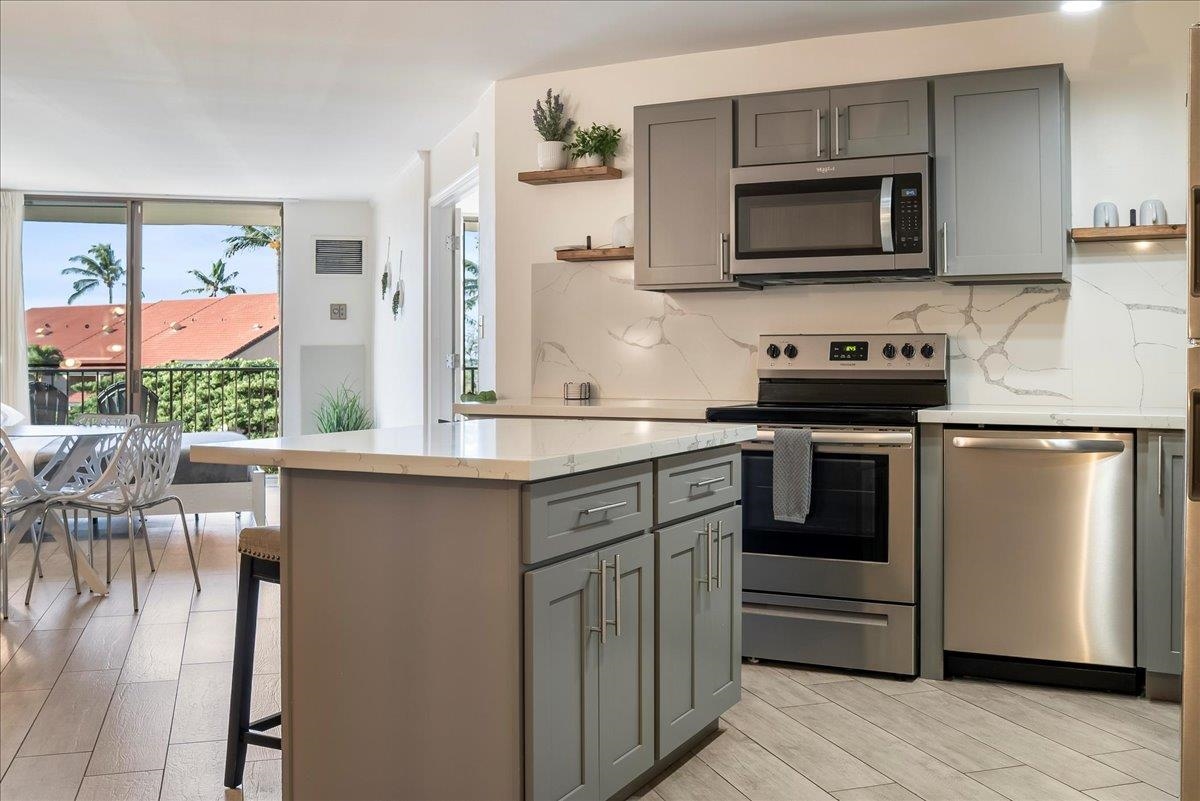 938 South Kihei Road, Unit 423 Kihei, HI 96753 - Photo 4 of 50 a kitchen with stainless steel appliances a stove microwave and refrigerator