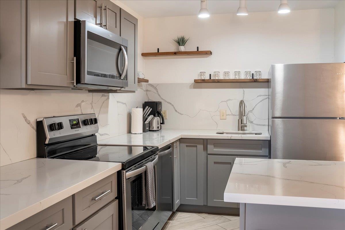 938 South Kihei Road, Unit 423 Kihei, HI 96753 - Photo 6 of 50 a kitchen with stainless steel appliances a sink a stove and cabinets