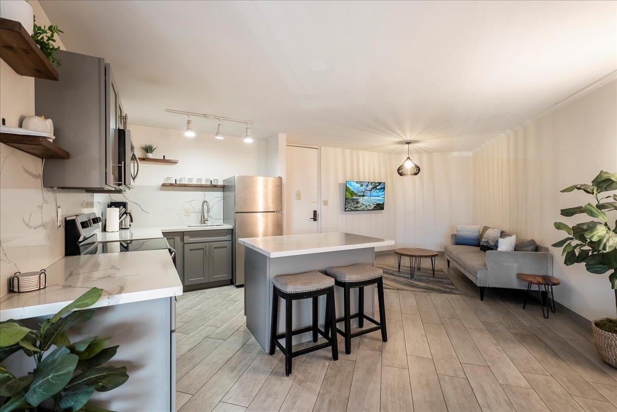 938 South Kihei Road, Unit 423 Kihei, HI 96753 - Photo 8 of 50 a living room with furniture a wooden floor and a sink