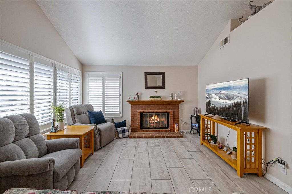 406 Country Club Drive Simi Valley, CA 93065 - Photo 20 of 56 a living room with furniture a flat screen tv and a fireplace