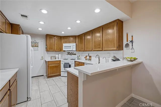 a white refrigerator freezer sitting in a kitchen