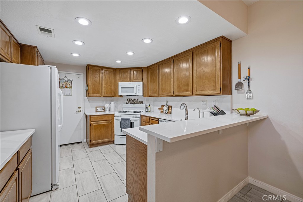 406 Country Club Drive Simi Valley, CA 93065 - Photo 29 of 56 a kitchen with a sink appliances and cabinets