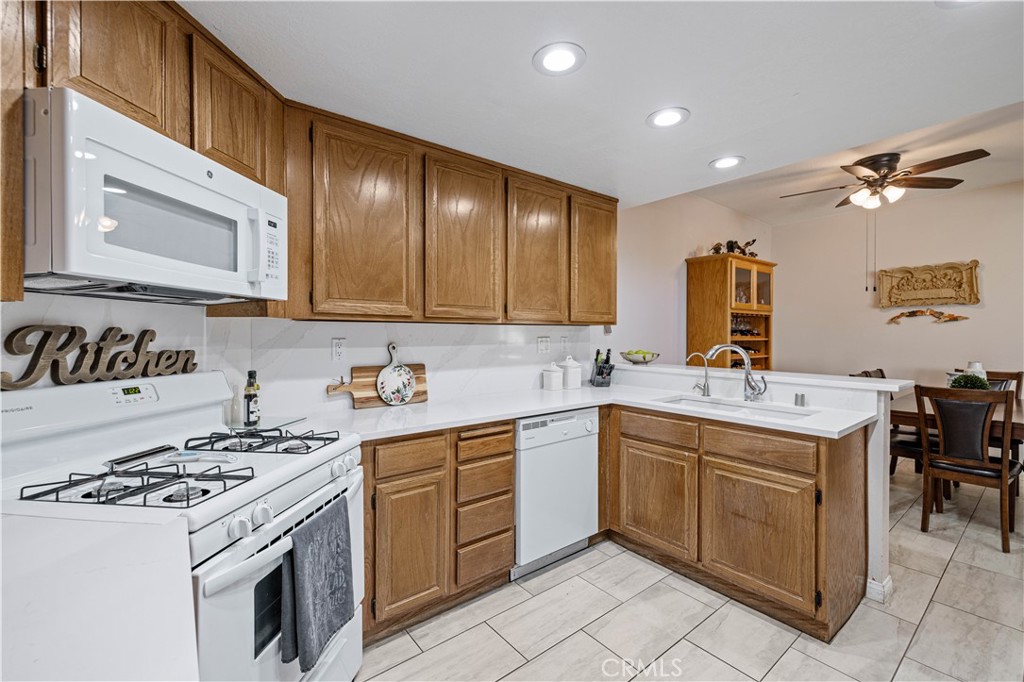 406 Country Club Drive Simi Valley, CA 93065 - Photo 30 of 56 a kitchen that has a sink and a stove in it