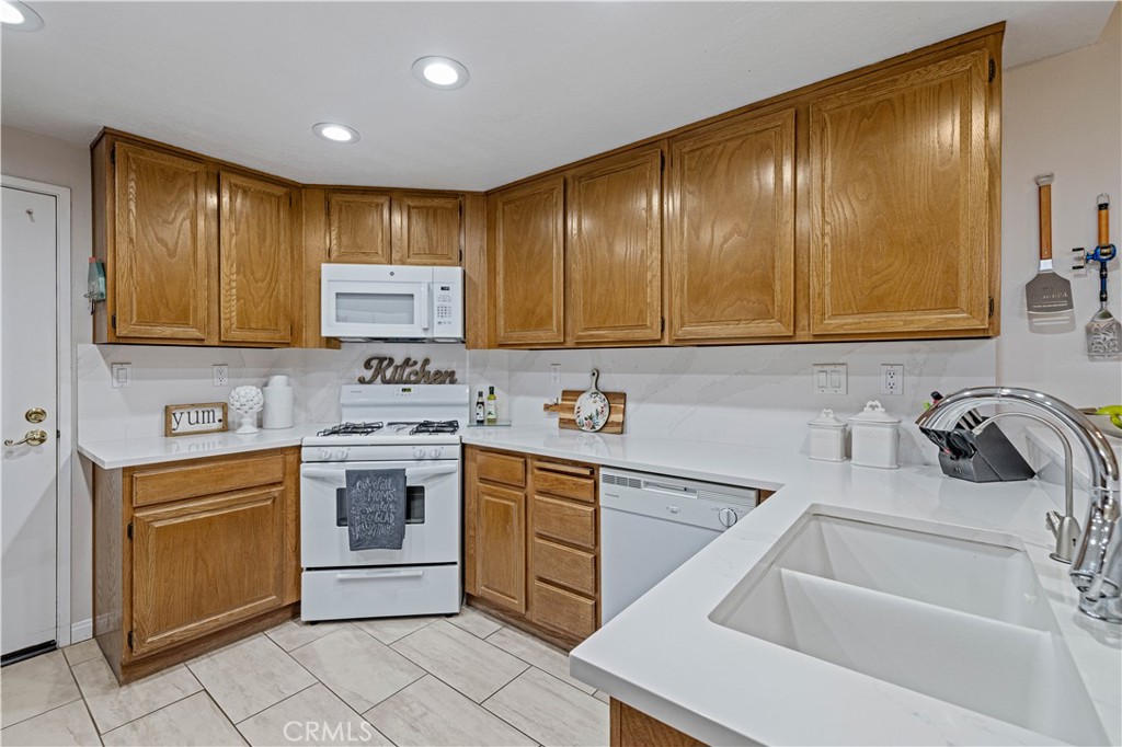 406 Country Club Drive Simi Valley, CA 93065 - Photo 33 of 56 a kitchen with a sink stove and microwave