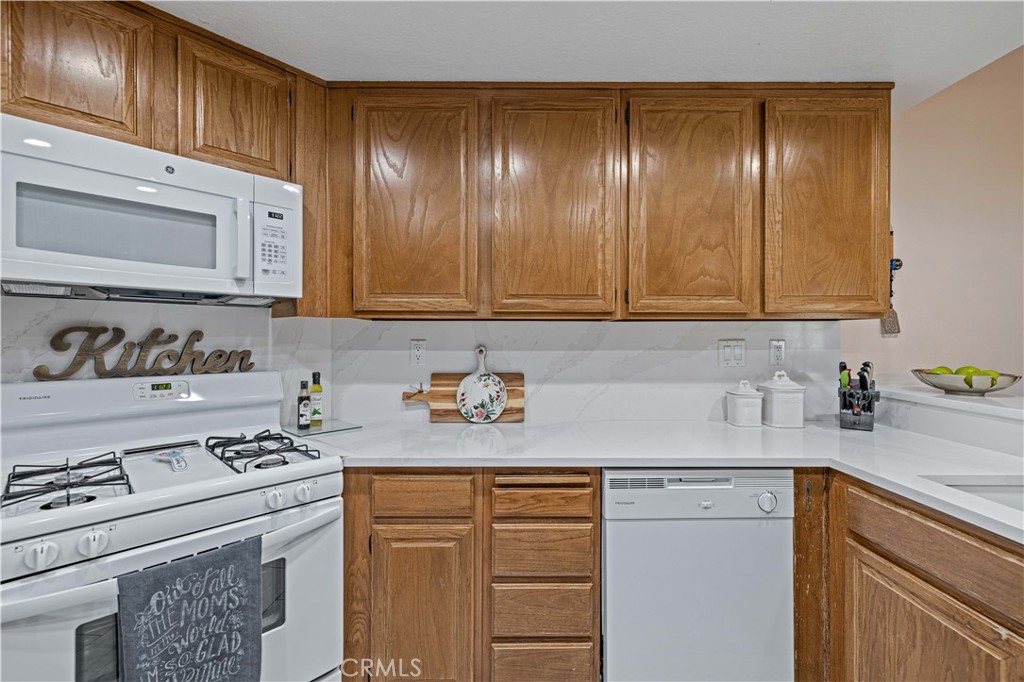 406 Country Club Drive Simi Valley, CA 93065 - Photo 34 of 56 a kitchen with stainless steel appliances granite countertop a sink stove and cabinets