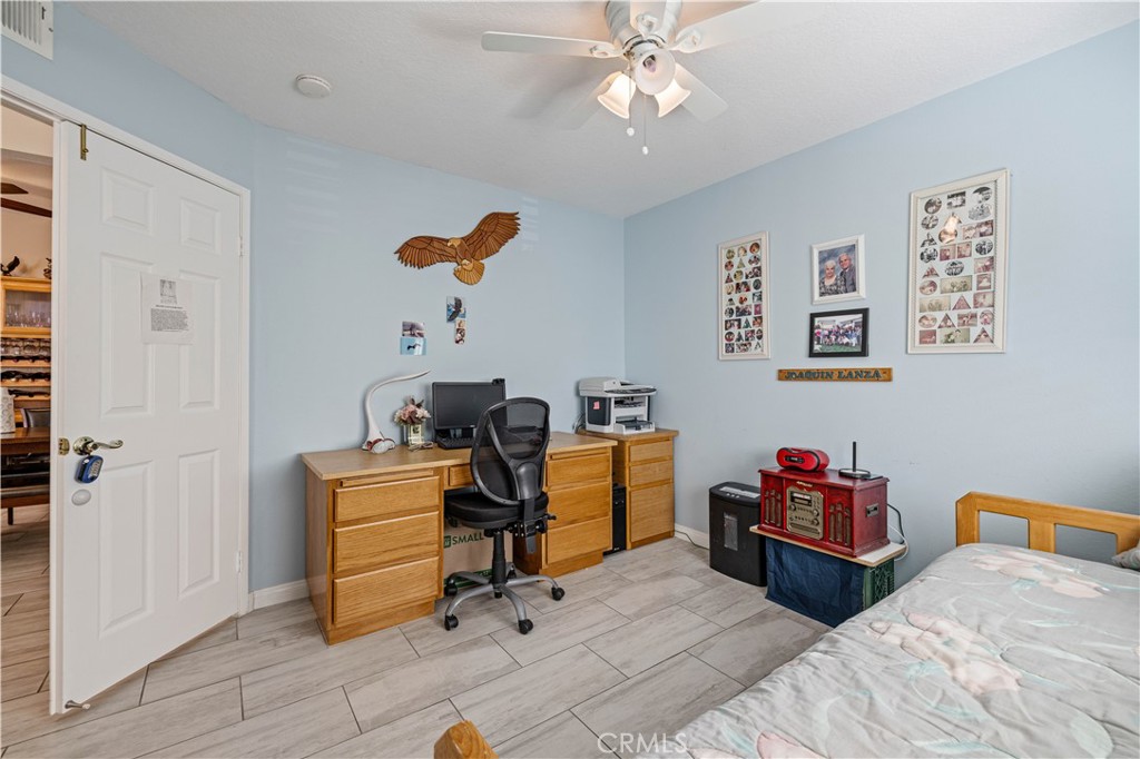406 Country Club Drive Simi Valley, CA 93065 - Photo 38 of 56 a bedroom with furniture and a chandelier