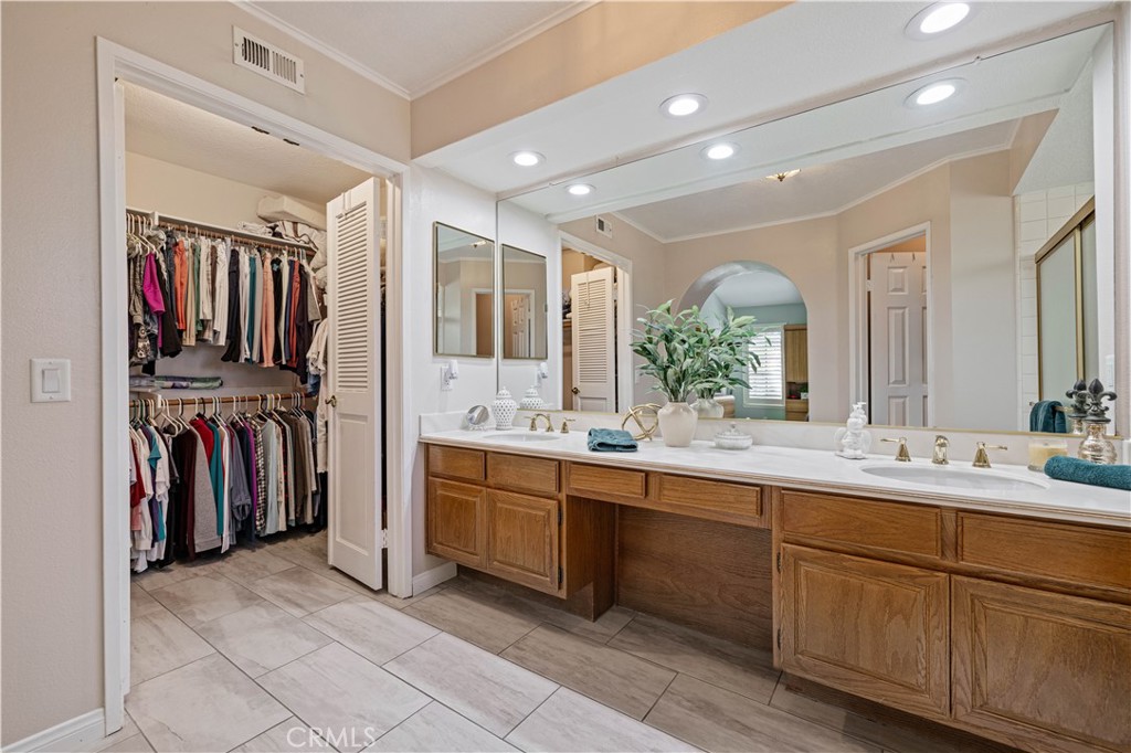 406 Country Club Drive Simi Valley, CA 93065 - Photo 45 of 56 a spacious bathroom with a double vanity sink and a large mirror