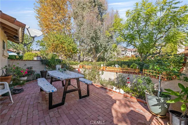a view of a patio with table and chairs and potted plants