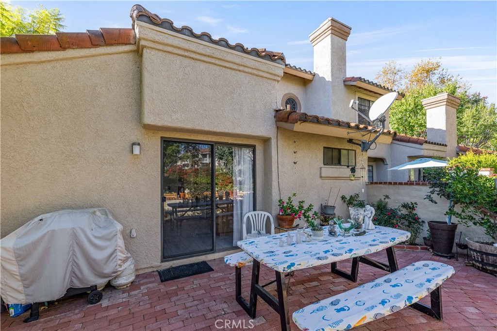 406 Country Club Drive Simi Valley, CA 93065 - Photo 49 of 56 a view of a dinning table and chair in the patio