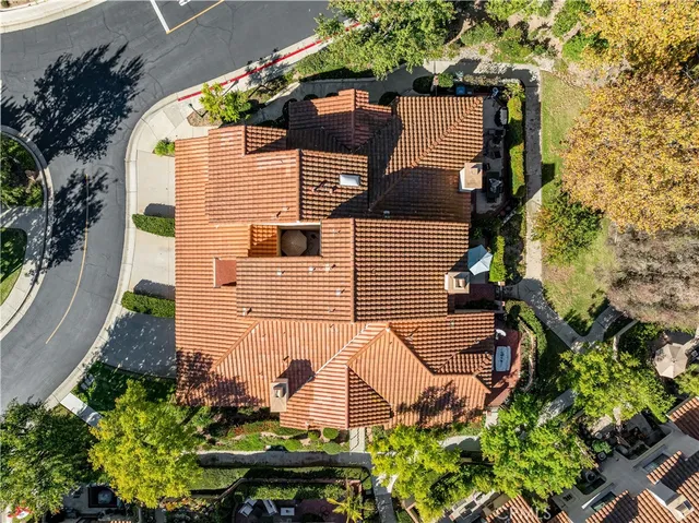 an aerial view of a house with a yard and potted plants