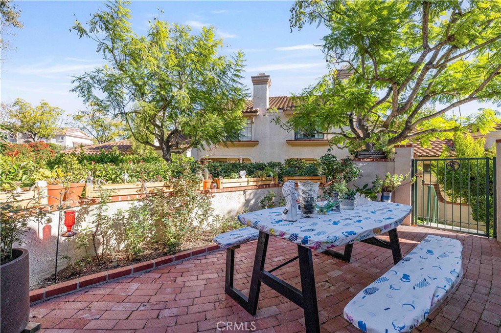 406 Country Club Drive Simi Valley, CA 93065 - Photo 52 of 56 a view of a patio with table and chairs and potted plants
