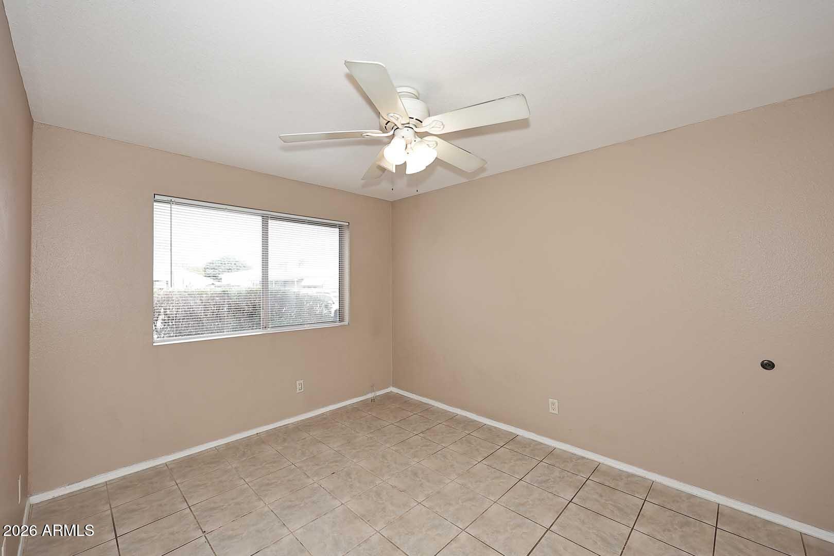 303 North Miller Road, Unit 1007 Scottsdale, AZ 85257 - Photo 23 of 45 an empty room with windows and fan