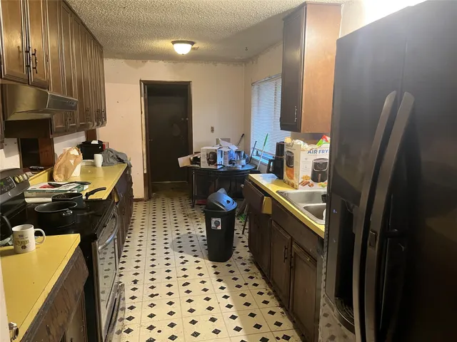 a kitchen with a sink stove and refrigerator