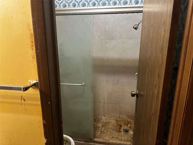 a bathroom with a glass shower door