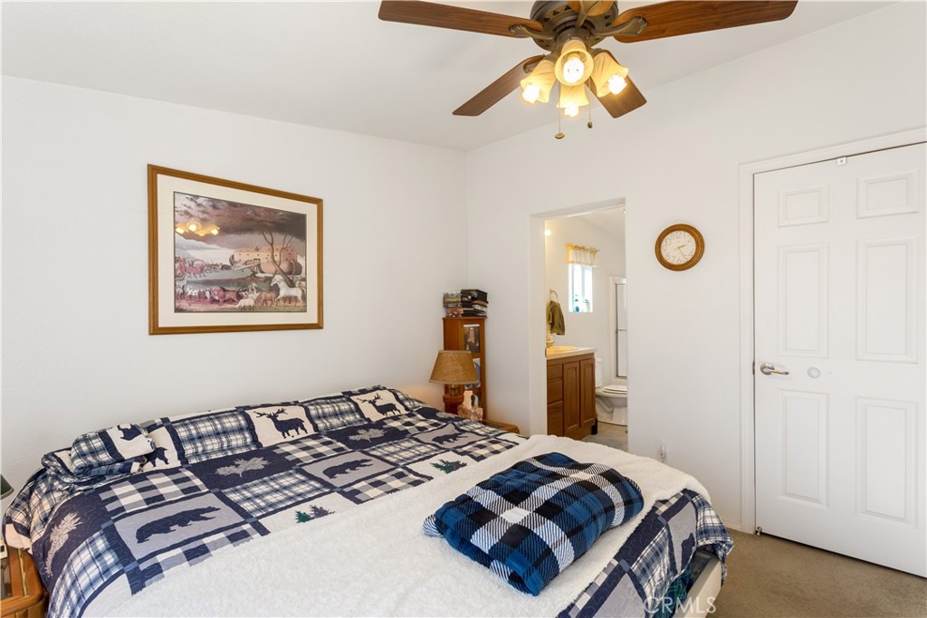 23700 Clement Way Idyllwild, CA 92549 - Photo 16 of 32 a bedroom with bed and a chandelier