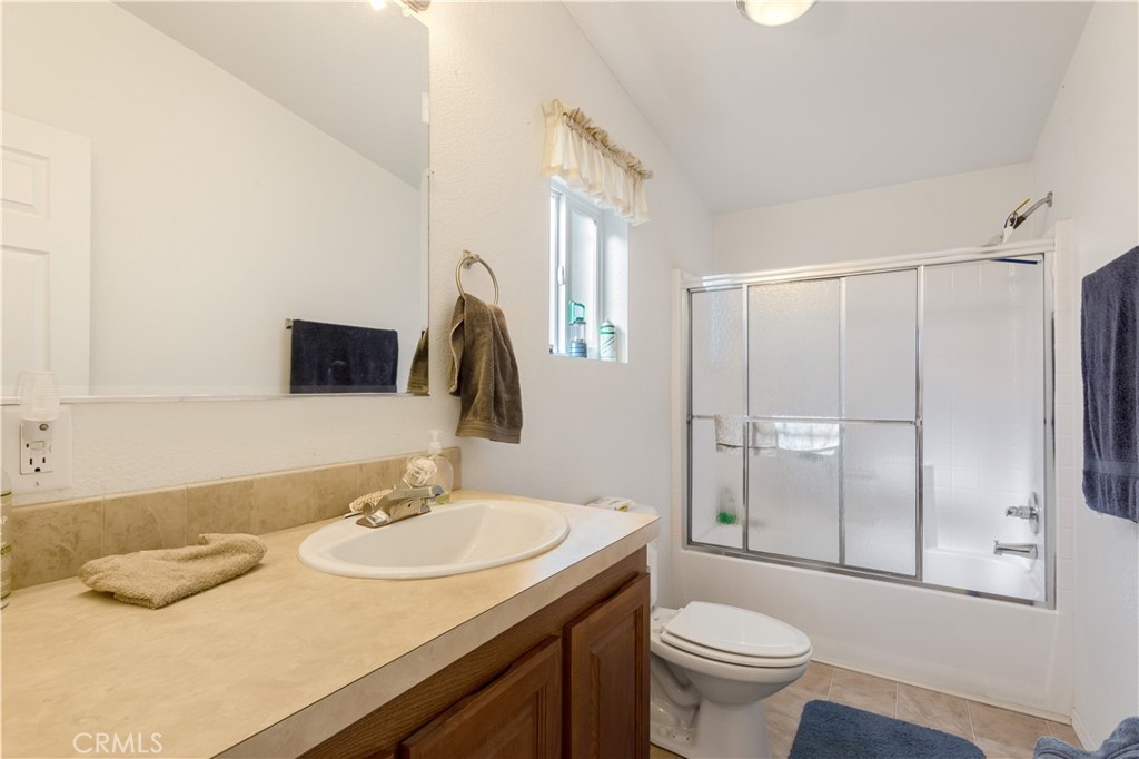 23700 Clement Way Idyllwild, CA 92549 - Photo 17 of 32 a bathroom with a granite countertop sink toilet and shower