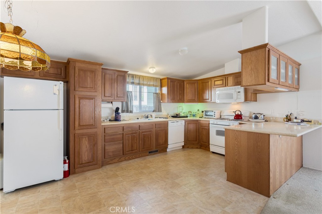 23700 Clement Way Idyllwild, CA 92549 - Photo 9 of 32 a kitchen with cabinets and a refrigerator