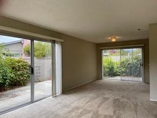 a kitchen with granite countertop white cabinets and stainless steel appliances