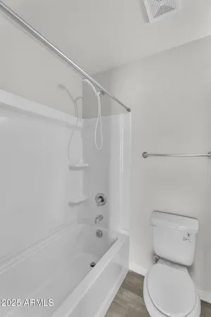 a bathroom with a toilet and a bathtub