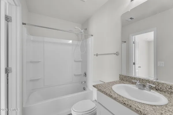a bathroom with a granite countertop sink toilet tub and shower